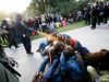 In this Friday, Nov. 18, 2011, photo University of California, Davis Police Lt. John Pike uses pepper spray to move Occupy UC Davis protesters while blocking their exit from the school's quad Friday in Davis, Calif. Two University of California, Davis pol In this Friday, Nov. 18, 2011, photo University of California, Davis Police Lt. John Pike uses pepper spray to move Occupy UC Davis protesters while blocking their exit from the school's quad Friday in Davis, Calif. Two University of California, Davis pol